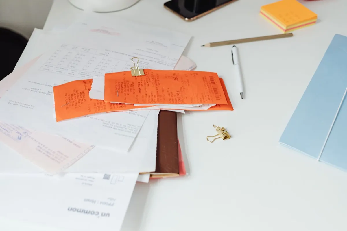 Receipts and paperwork spread across a desk